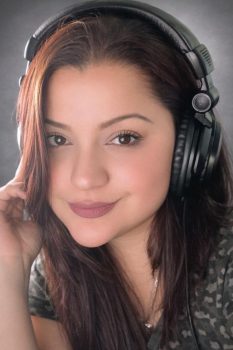 Angie Acosta Latin American Spanish voice talent wearing studio headphones in professional recording environment