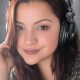 Angie Acosta Latin American Spanish voice talent wearing studio headphones in professional recording environment